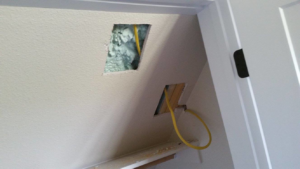 Electrical wiring (yellow Romex) visible in a wall during rough-in installation by Northern Lights Electric Company in Sheridan, WY.