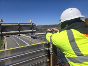 An electrician performing electrical work on a highway structure for 2 Live Wires in Slatington, PA.