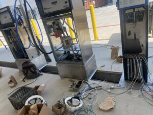 Electrical work being performed on the internal components and wiring of fuel dispensers by Ultralight Electric in Houston, TX.
