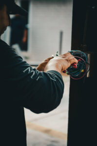 An electrician from Mattox Electric, LLC in Dallas, TX, expertly connecting wires inside an electrical box during an installation.