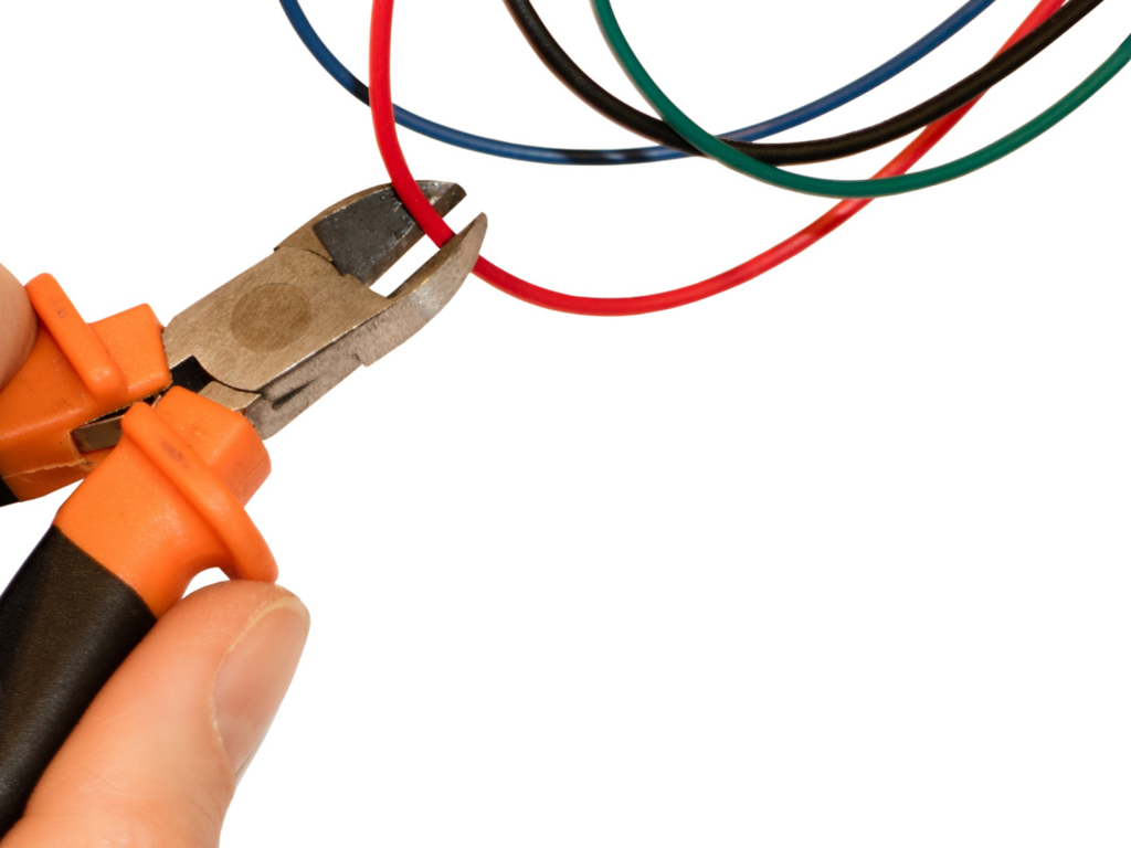An electrician cutting electrical wire with pliers for Four Corners Electric Co., Inc. in Farmington, NM