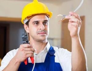 A Parker Electric electrician in Hilliard, OH, holding electrical wires and tools.