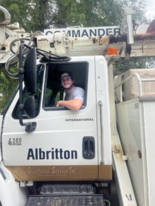 An Albritton Electrical Service, Inc. electrician in a branded bucket truck in Tallahassee, FL.
