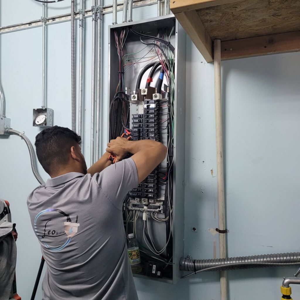An electrician from LeoElectricservice inspecting a ceiling opening for electrical work in a kitchen in Frisco, TX.