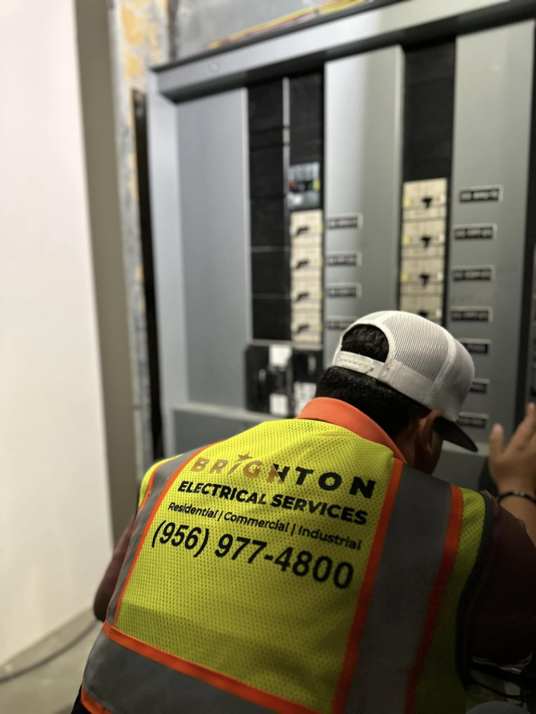 An electrician from Brighton Electrical Services inspecting an electrical panel in Laredo, TX.