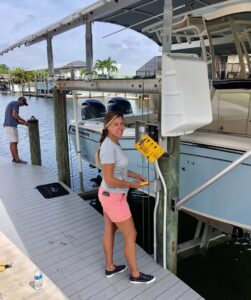 An electrician installing electrical wiring for a boat lift at Sound Electric LLC in Saint James City, FL.