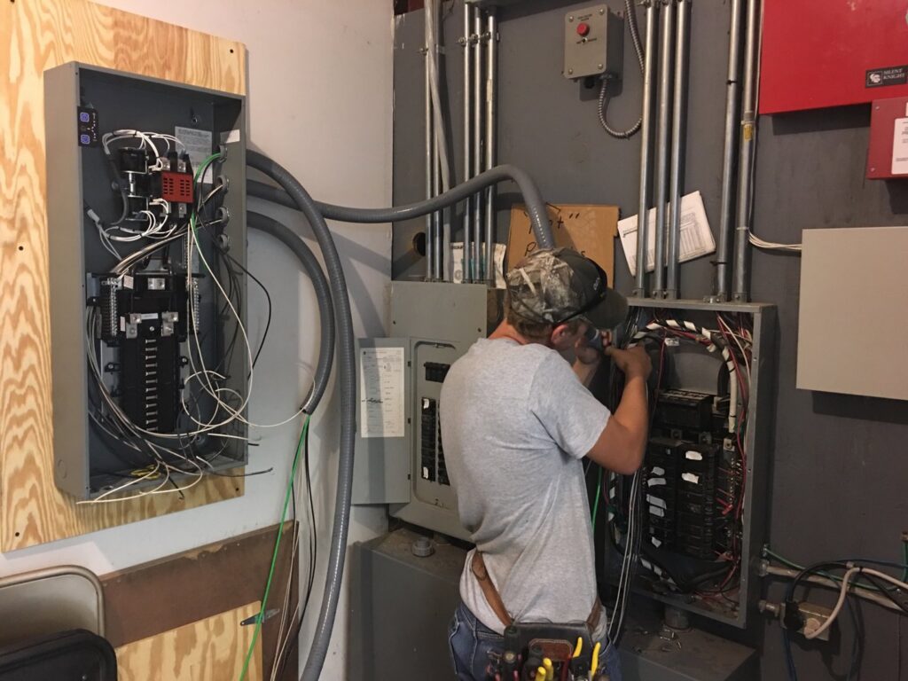 An electrician from Bonham Electric, Inc. installing a new breaker panel in Sacramento, CA.