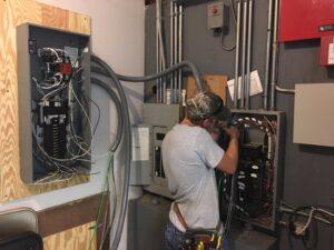 An electrician from Bonham Electric, Inc. installing a new breaker panel in Sacramento, CA.