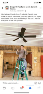 An electrician from Creekside Electric installing a new ceiling fan in Clarence Center, NY.