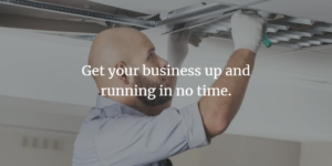 An electrician installing or repairing ceiling lights for a business at Brase Electrical Contracting Corp in Omaha, NE.