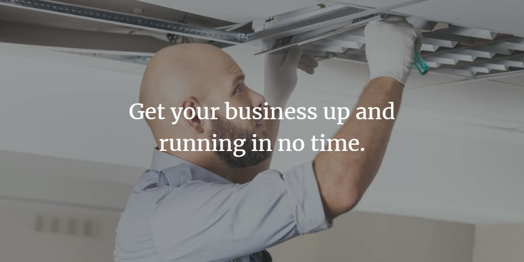 An electrician installing or repairing ceiling lights for a business at Brase Electrical Contracting Corp in Omaha, NE.