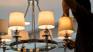 An electrician installing or repairing a chandelier for Illiana Electrical in Whiting, IN