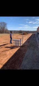 An electrician installing outdoor electrical conduit and utility boxes for Enid Electric in Enid, OK