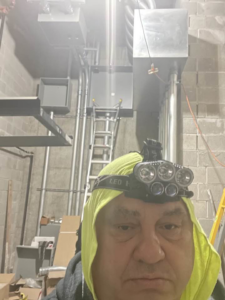 An electrician from Sttrango Electric Company installing electrical conduits and junction boxes in Chicago, IL.