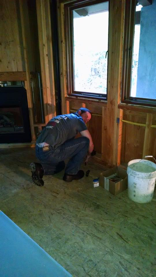 An electrician installing an electrical outlet or switch in a framed wall for Kavanagh Electric in Fresno, CA.