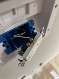 An electrician from Sparrow Electric, LLC installing a new electrical outlet in Denver, CO.