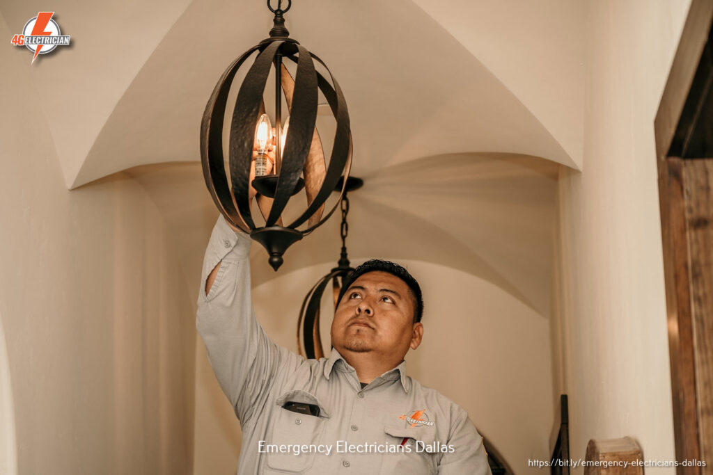 An electrician from 4G Electrician installing a decorative light fixture in a home in Dallas, TX