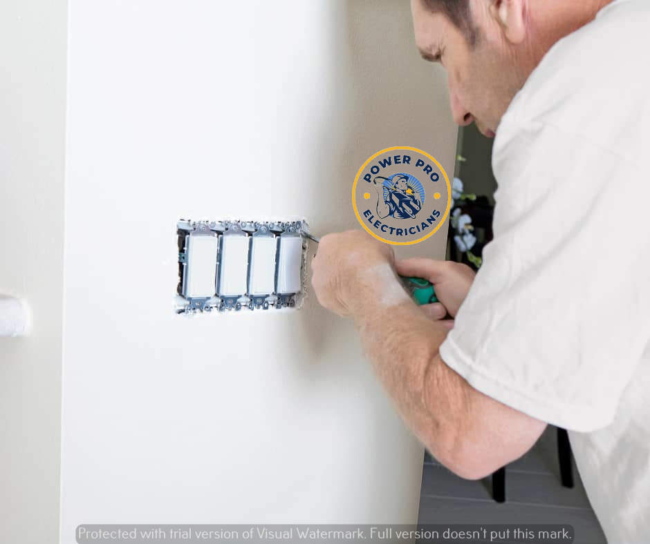 An electrician installing new light switches on a wall for Power Pro Electricians Roanoke, VA