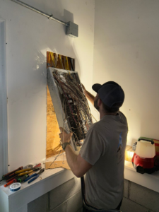 An electrician from Weiss Electric LLC installing a new electrical panel into a wall opening in Saint Charles, MO.