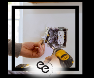An electrician installing an electrical outlet and light switch with a power drill for Elemental Electrical in Chattanooga, TN.