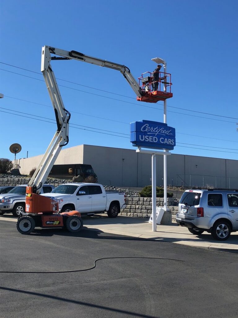 An electrician from Valley Electric Inc in Lewiston, ID, installing overhead conduits and wiring in a retail store.