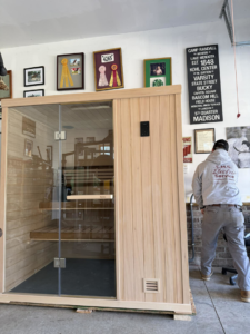 An electrician from C.M.S Electrical installing an electrical panel for a sauna in Staley, NC.