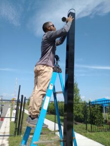 An electrician installing a security camera on a pole for Wirenut Technologies LLC in Brandon, FL.