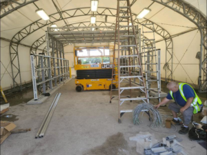 An electrician installing electrical wires and components on a commercial project site for Wire Nutz LLC in Vancouver, WA