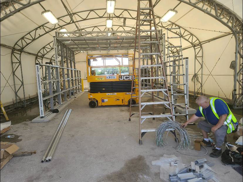 An electrician installing electrical wires and components on a commercial project site for Wire Nutz LLC in Vancouver, WA