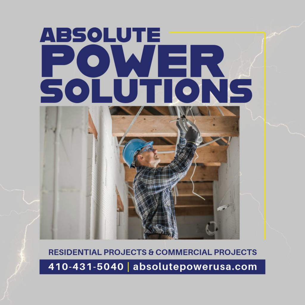 An electrician installing electrical wiring in a ceiling for Absolute Power Solutions USA in Annapolis, MD.