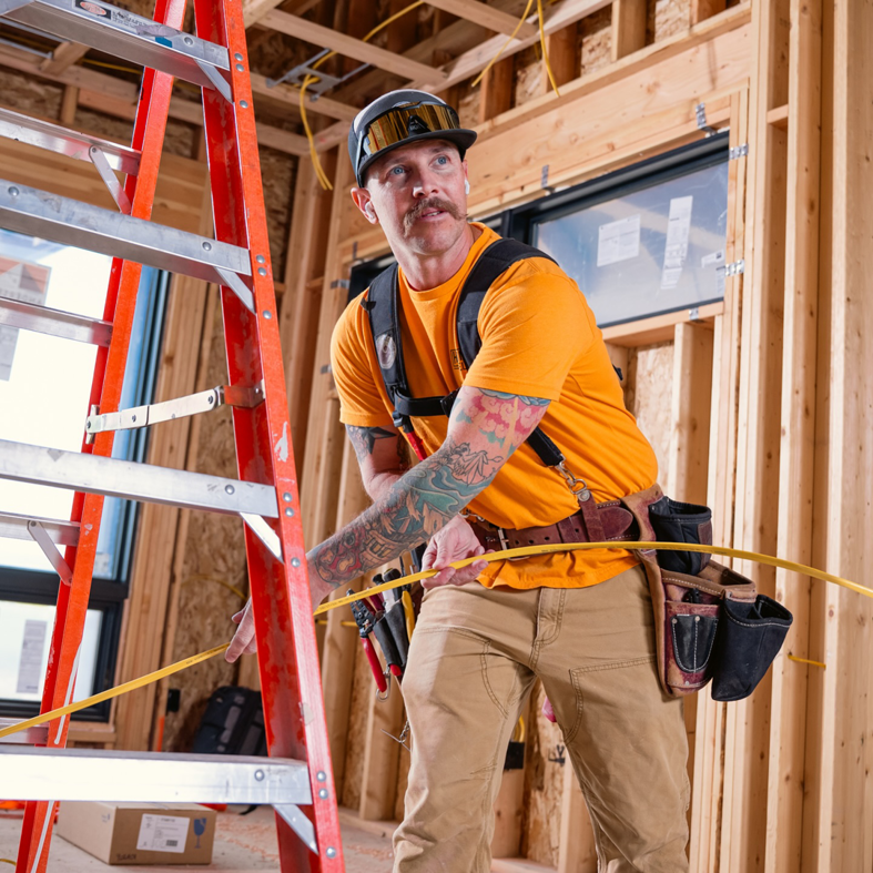 An electrician installing electrical wiring at a construction site for Hometown Electric in Delta, CO.