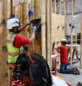 An electrician installing electrical wiring in a framed wall at MetroPower, Inc. in Albany, GA.