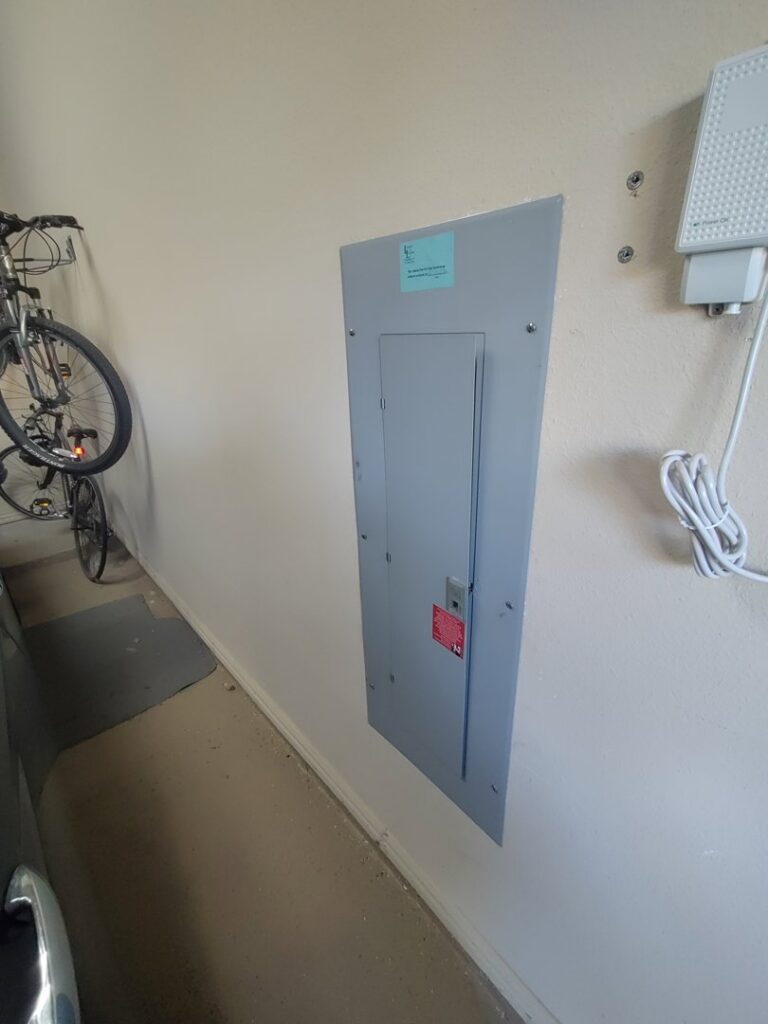 A ladder in a hallway with fluorescent lighting, indicating electrical work by LeoElectricservice in Frisco, TX.
