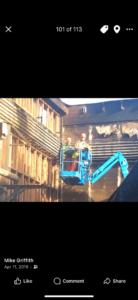 An electrician from GM Electric Inc. on a boom lift working on industrial conduits and wiring in Kalispell, MT.