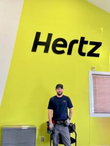 An electrician from Dr. Sparky wearing a tool belt on a commercial job site in Nashville, TN