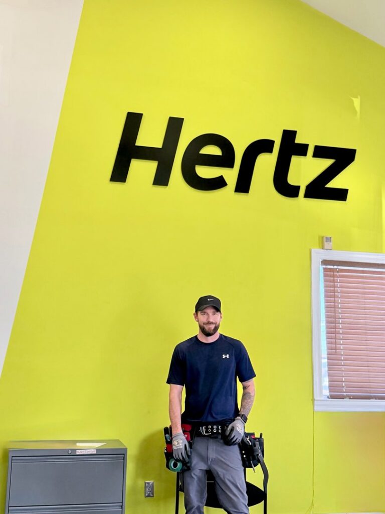 An electrician from Dr. Sparky wearing a tool belt on a commercial job site in Nashville, TN