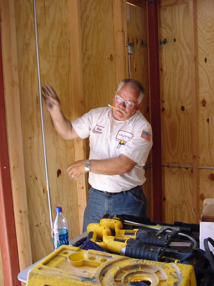 An Accel Electric electrician on a job site with power tools and conduit visible in Peoria, AZ.