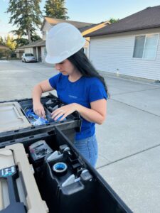 An electrician from Circuit Masters, Inc. organizing tools in a work truck in Billings, MT.