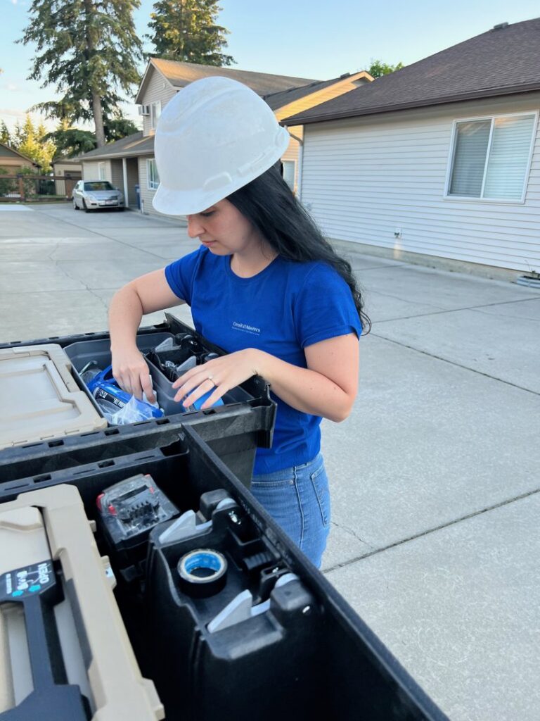 An electrician from Circuit Masters, Inc. organizing tools in a work truck in Billings, MT.