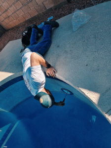 An electrician from Retro Electric AZ performing electrical work on a residential swimming pool in Higley, AZ.