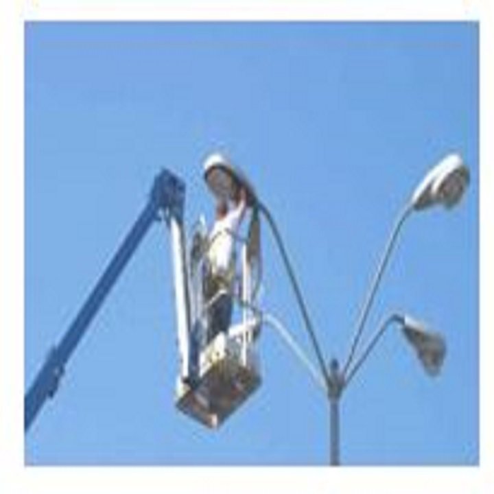 An electrician in a boom lift repairing a street light for Gerard A LaFlamme Inc in Londonderry, NH.
