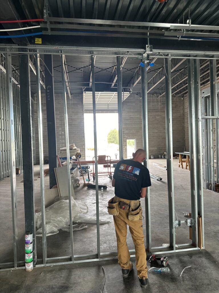 An Electric Today electrician performing rough-in wiring during new construction in Indianapolis, IN.