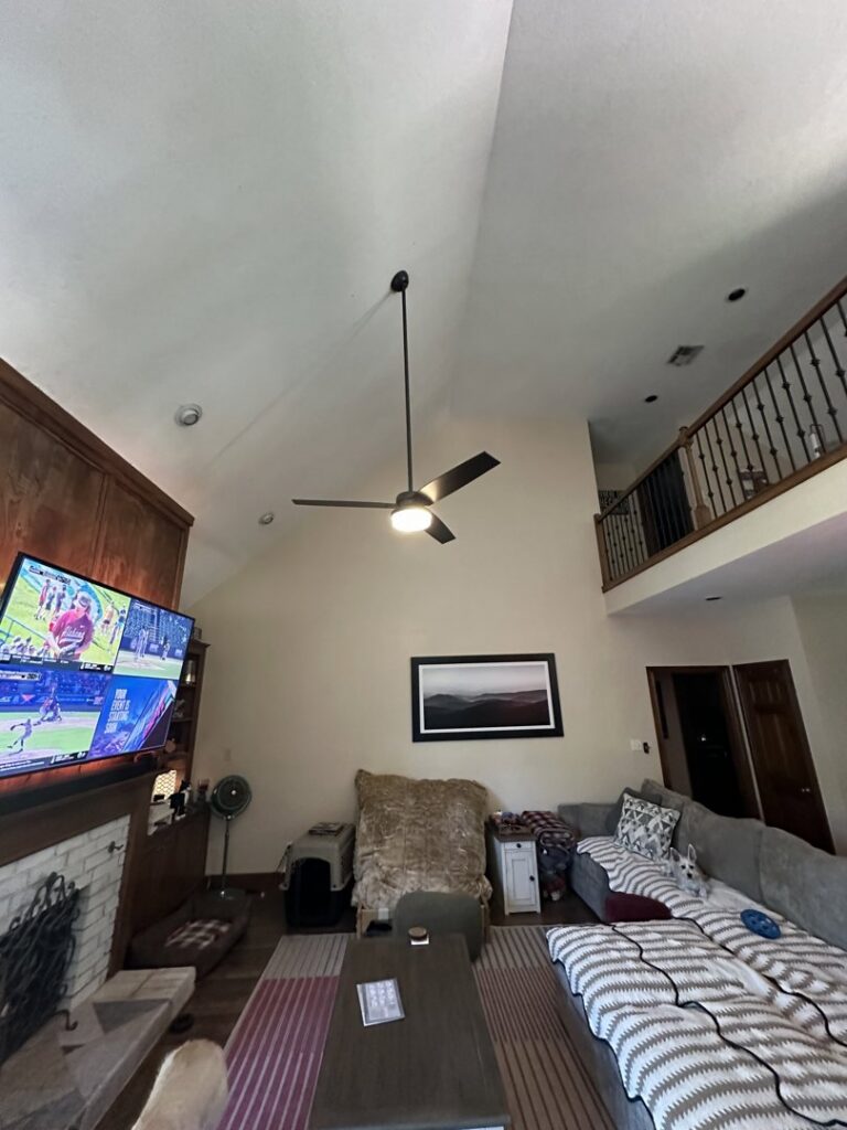 An electrician from Top notch electric llc servicing an open electrical panel in Clearwater, FL.