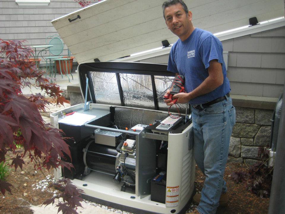 An electrician from Barrios Electric LLC servicing an outdoor generator in Norwalk, CT.