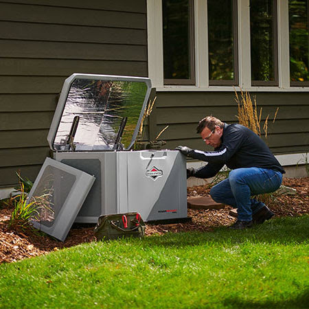 An electrician from VerPlank Electric servicing a residential standby generator in Grand Rapids, MI