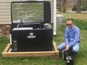 An electrician from Volt Doctors Raleigh, NC, servicing an outdoor Briggs & Stratton generator.