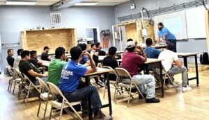 Electrician students learning about electrical and solar panels in a classroom at Escuela Tecnica ABC in North Chicago, IL