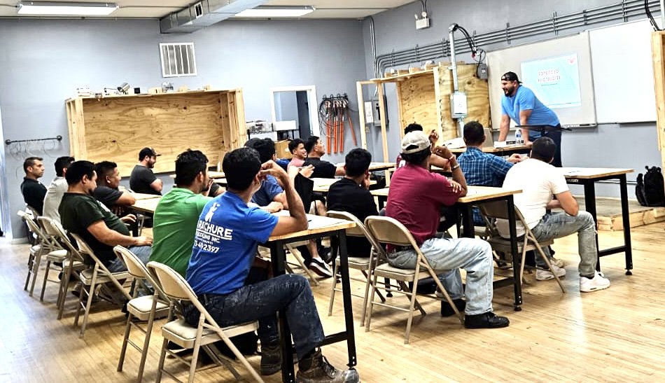 Electrician students learning about electrical and solar panels in a classroom at Escuela Tecnica ABC in North Chicago, IL