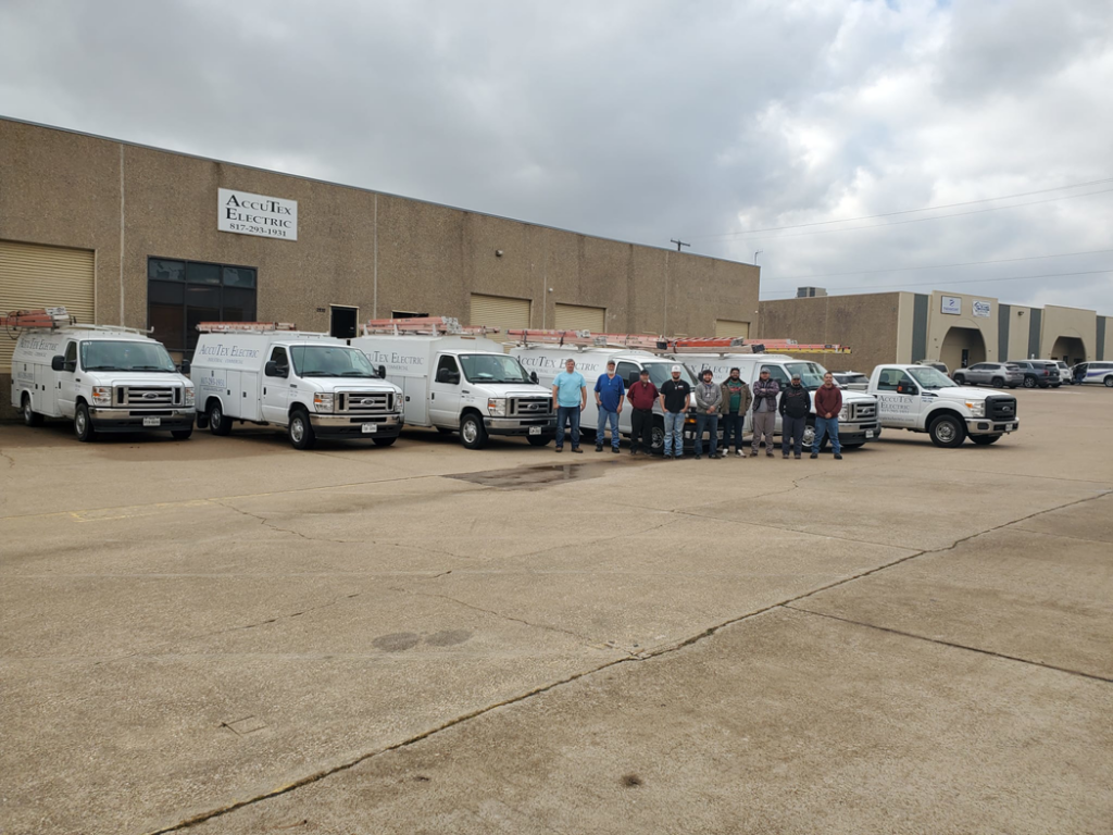 The AccuTex Electric team standing proudly with their service vans and trucks in Fort Worth, TX.