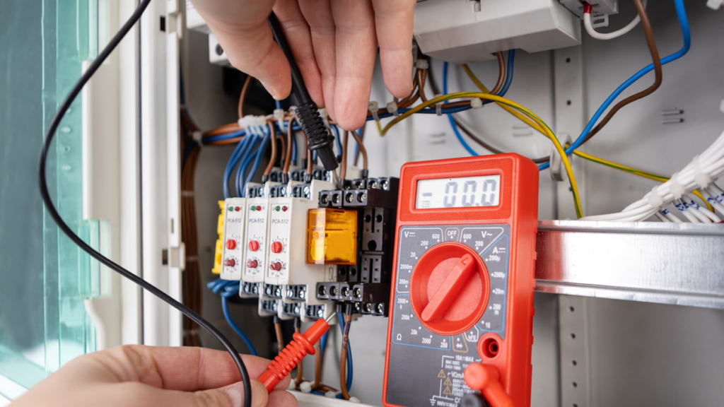 An electrician testing an electrical panel with a multimeter at Illiana Electrical in Whiting, IN
